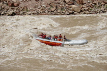 USA, Utah, Canyonlands National Park, An 18' rowing raft navigates through the Big Drop II rapid in Cataract Canyon on the Colorado River.  Flow level was 51,000 cfs.