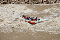 USA, Utah, Canyonlands National Park, A 33' S-rig raft navigates through the Big Drop II rapid in Cataract Canyon on the Colorado River.  Flow level was 51,000 cfs.