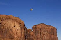 USA, Arizona, Monument Valley, A hot air balloon flying over Elephant Butte during the Balloon Festival in the Navajo Tribal Park