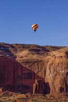 USA, Arizona, Monument Valley, A hot air balloon flying during Balloon Festival in the Navajo Tribal Park.