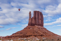 USA, Arizona, Monument Valley, A hot air balloon flying over the West Mitten during the Balloon Festival in the Navajo Tribal Park in Arizona.