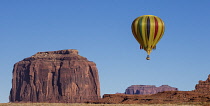 USA, Arizona, Monument Valley, Hot air balloon flying by Merrick Butte during Balloon Festival in the  Navajo Tribal Park.