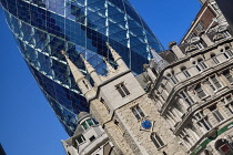 England, London, The Swiss Re building 30 St Mary Axe, alternatively known as the Gherkin, commercial skyscraper designed by architect Sir Norman Foster and opened in April 2004 with St Andrew Undersh...