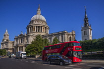 England, London, View of St Paul's Cathedral from Cannon Street with iconic red London bus passing by.