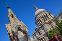 England, London, View of St Paul's Cathedral from Cannon Street with iconic red London bus passing by.