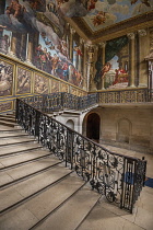 England, Richmond upon Thames. Hampton Court Palace, The Kingâs Staircase with a wrought iron balustrade and a mural painted by the Italian artist Antonio Verrio titled Victory of Alexander over th...