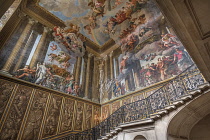 England, Richmond upon Thames. Hampton Court Palace, The Kingâs Staircase with a wrought iron balustrade and a mural painted by the Italian artist Antonio Verrio titled Victory of Alexander over th...