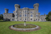 Republic of Ireland, County Wexford, Gothic Revival Johnstown Castle with a fountain in the foreground.