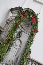 Belgium, Brussels, Manneken Pis with Christmas decoration surrounding it.