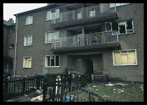 Scotland, Glasgow, Easter House flats with smashed boarded up windows.