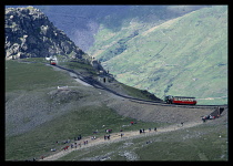 Transport, Rail, Steam train, Distant view of two trains of the Snowdon Mountain Railway and walkers near the summit of Mount Snowdon