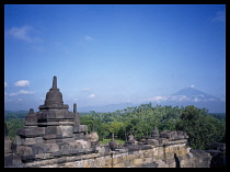 Indonesia, Java , Central, Borobudur Temple ruins, Buddhist monument constructed in the early 9th century AD, Mount Merapi in the distance.