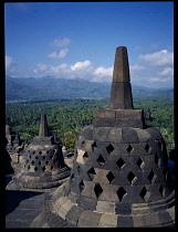 Indonesia, Java, Central, Borobudur Temple ruins.  Buddhist monument constructed in the early 9th century.  Latticed stupas on the upper circular terraces.