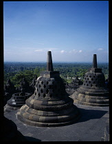 Indonesia, Java , Central, Borobudur Temple ruins, Buddhist monument constructed in the early 9th century latticed stupas on the upper circular terraces.