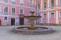 Germany, Bavaria, Berchtesgaden, The Royal Castle facade with a fountain in the foreground.