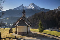 Germany, Bavaria, Berchtesgaden, The Chapel of the Beatitudes above the town on Lockstein Hill, rear view with the snow covered Watzmann Mountain in the distance.