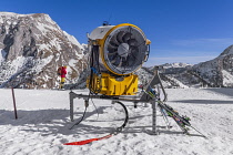 Germany, Bavaria, Berchtesgaden, Berchtesgadener Alps, snow machine on  the summit of the Jenner Mountain with skiers in the background.