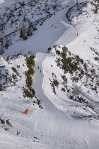 Germany, Bavaria, Berchtesgaden, Berchtesgadener Alps, Ski slopes on the summit of the Jenner Mountain with skiers in the distance.