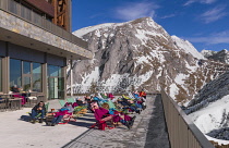 Germany, Bavaria, Berchtesgaden, Berchtesgadener Alps, People taking the sun on deck chairs on the summit of the Jenner Mountain.