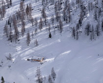 Germany, Bavaria, Berchtesgaden, Cabin in snow covered landscape as seen from the summit of the Jenner Mountain.