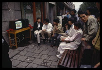 China, Quinghai, Xining, Group of people participating in karaoke on the street.