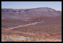 Namibia, Near Tsarishoogte Pass, Dirt road running through semi desert scrub land.