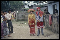 Indonesia, Sumatra, Brastagi , Also known as Berastagi, Wedding couple standing on village street. .