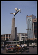 China, Inner Mongolia, Hohhot, Statue above a busy street of a golden horse representing the freedom of the Mongolian people.