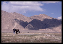 China, Xinjiang, Man with horse on the plateau near Taxkurgan on the  border with Pakistan.