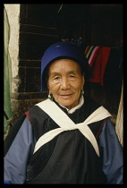 China, Lijiang, Portrait of Naxi woman in traditional dress.