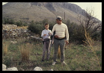 Greece, Peloponnese, Mani, Man and boy hunters shooting birds.