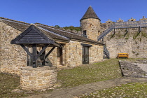 Ireland, County Leitrim, Dromahair, Parkes Castle, Wishing well in the courtyard with a tower located on the defensive walls.