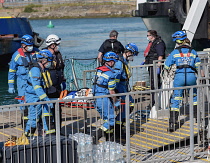 England, Kent, Dover, Coast Guard Rescue officers landing injured Asylum Seekers picked up in the English Channel.