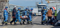 England, Kent, Dover, Coast Guard Rescue officers landing injured Asylum Seekers picked up in the English Channel.