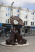 England, East Sussex, Brighton, Norfolk Square, Waves of Compassion Sculpture created by Steve Geliot, formed of three original Old Steine dolphins, which were designed by Amon Henry Wilds as part of...