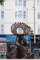 England, East Sussex, Brighton, Norfolk Square, Waves of Compassion Sculpture created by Steve Geliot, formed of three original Old Steine dolphins, which were designed by Amon Henry Wilds as part of...