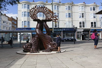 England, East Sussex, Brighton, Norfolk Square, Waves of Compassion Sculpture created by Steve Geliot, formed of three original Old Steine dolphins, which were designed by Amon Henry Wilds as part of...