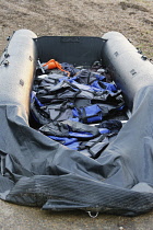 England, Kent, Dungeness, Discarded rubber dingy with lifejackets used by migrants who had crossed the channel.