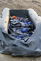 England, Kent, Dungeness, Discarded rubber dingy with lifejackets used by migrants who had crossed the channel.