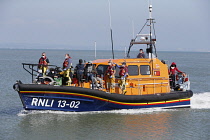 England, Kent, Dungeness, RNLI, helping migrants who have crossed the channel onto the beach.