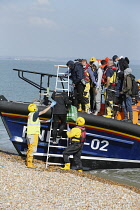 England, Kent, Dungeness, RNLI, helping migrants who have crossed the channel onto the beach.