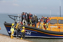 England, Kent, Dungeness, RNLI, helping migrants who have crossed the channel onto the beach.