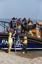England, Kent, Dungeness, RNLI, helping migrants who have crossed the channel onto the beach.