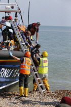 England, Kent, Dungeness, RNLI, helping migrants who have crossed the channel onto the beach, Susina 5yrs old and traveled with her mum from Eritrea.