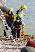 England, Kent, Dungeness, RNLI, helping migrants who have crossed the channel onto the beach, Susina 5yrs old and traveled with her mum from Eritrea.