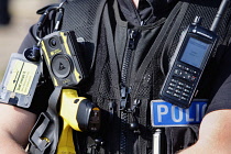 England, Kent, Dungeness, Close up of Police officers stab proof vest with communications and Taser etc.