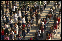 India, Rajasthan, Ramgarh, Outdoor school assembly. Children standing in lines praying.