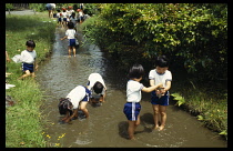 Japan, Kyoto, Children on school trip by river.