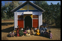 India, Andhra Pradesh, General, Pupils sitting on ground outside nursery school.