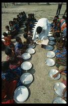 India, West Bengal, General, School feeding programme. Line of schoolchildren receiving food.